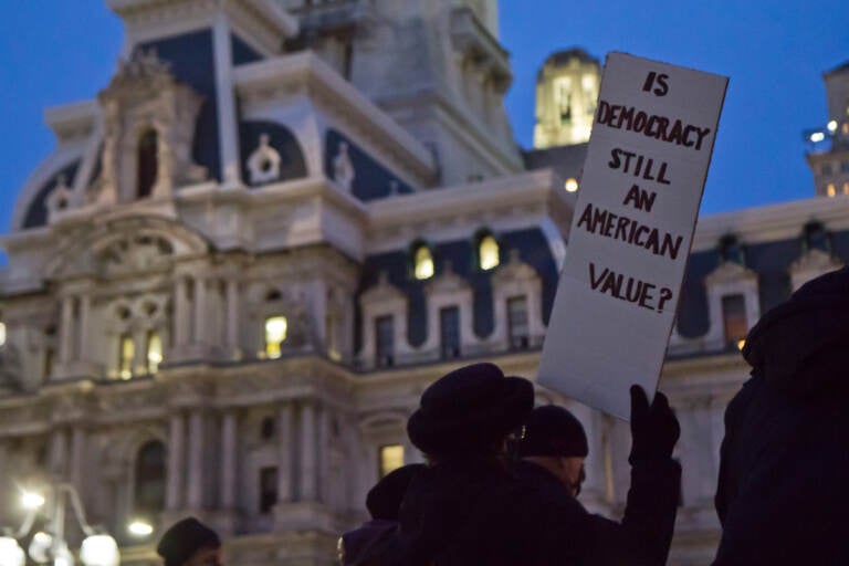 About 40 people gathered in Philadelphia’s Thomas Paine Plaza at a candlelight vigil remembering the attacks on the U.S. Capital a year later, on January 6, 2022. (Kimberly Paynter/WHYY)