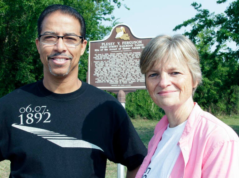 FILE - Keith Plessy and Phoebe Ferguson, descendants of the principals in the Plessy V. Ferguson court case, pose for a photograph in front of a historical marker in New Orleans, on Tuesday, June 7, 2011.  Homer Plessy, the namesake of the U.S. Supreme Court’s 1896 “separate but equal” ruling, is being considered for a posthumous pardon. The Creole man of color died with a conviction still on his record for refusing to leave a whites-only train car in New Orleans in 1892.  (AP Photo/Bill Haber, File)