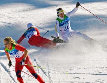 FILE - Norway's Vibeke Skofterud, left, escapes a crash involving Sweden's Norgren Johansson, right, and Poland's Paulina Maciuszek in the women's 15-kilometer pursuit cross country skiing event at Whistler Olympic Park on February 19, 2010, at the 2010 Vancouver Olympic Winter Games in Whistler, B.C. Many top Nordic skiers and biathletes say crashes are becoming more common as climate change reduces the availability of natural snow, forcing racers to compete on tracks with the manmade version. (AP Photo/Andrew Vaughan, CP, File)