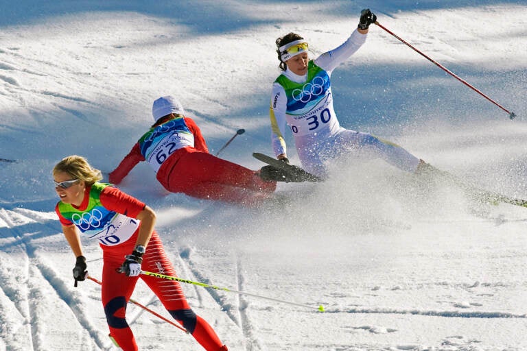 FILE - Norway's Vibeke Skofterud, left, escapes a crash involving Sweden's Norgren Johansson, right, and Poland's Paulina Maciuszek in the women's 15-kilometer pursuit cross country skiing event at Whistler Olympic Park on February 19, 2010, at the 2010 Vancouver Olympic Winter Games in Whistler, B.C. Many top Nordic skiers and biathletes say crashes are becoming more common as climate change reduces the availability of natural snow, forcing racers to compete on tracks with the manmade version. (AP Photo/Andrew Vaughan, CP, File)