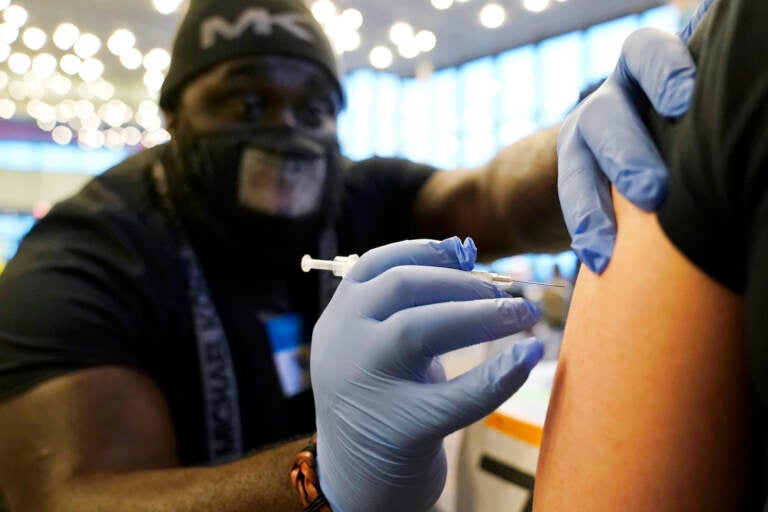 Close-up of a nurse about to vaccinate someone.