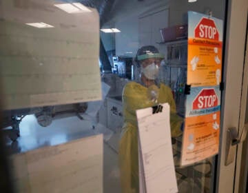 Registered nurse Morgan Flynn works inside a patient's room