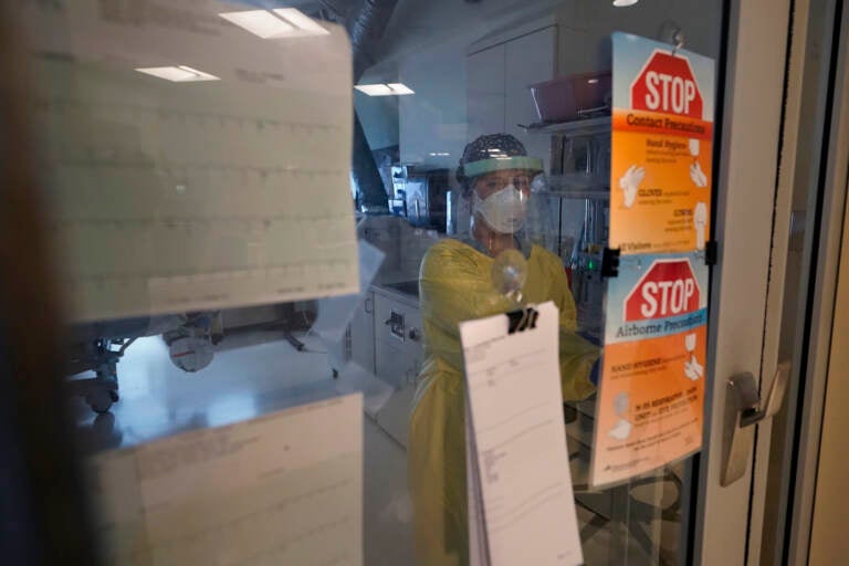 Registered nurse Morgan Flynn works inside a patient's room