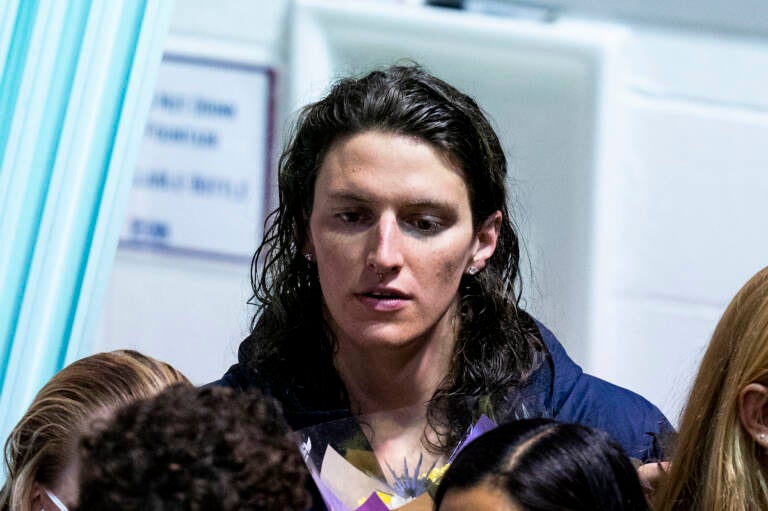 Pennsylvania's Lia Thomas looks on as she celebrates senior day with her teammates during a swim meet, Saturday, Jan. 8, 2022, in Philadelphia. The NCAA has adopted a sport-by-sport approach for transgender athletes, bringing the organization in line with the U.S. and International Olympic Committees. NCAA rules on transgender athletes returned to the forefront when Penn swimmer Lia Thomas started smashing records this year