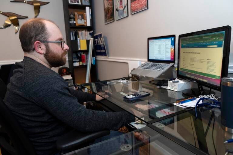Ethan Miller works on his taxes at home in Silver Spring, Md., Friday, Jan., 21, 2022. (AP Photo/Jacquelyn Martin)