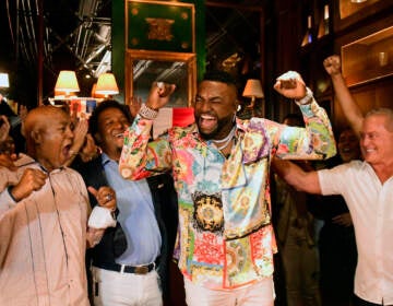 Former Boston Red Sox star David Ortiz, center, celebrates his election to the baseball hall of fame with his father Leo Ortiz, left, MLB Hall of Fame Pedro Martinez, second left, and Fernando Cuzza, right, moments after receiving the news in Santo Domingo, Dominican Republic, Tuesday, Jan. 25, 2022. (AP Photo/Manolito Jimenez)
