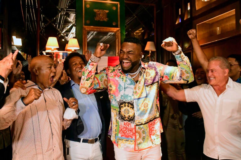 Former Boston Red Sox star David Ortiz, center, celebrates his election to the baseball hall of fame with his father Leo Ortiz, left, MLB Hall of Fame Pedro Martinez, second left, and Fernando Cuzza, right, moments after receiving the news in Santo Domingo, Dominican Republic, Tuesday, Jan. 25, 2022. (AP Photo/Manolito Jimenez)