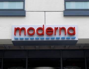 A sign marks an entrance to a Moderna, Inc., building, Monday, May 18, 2020, in Cambridge, Mass. Moderna announced Monday that an experimental vaccine against the coronavirus showed encouraging results in very early testing, triggering hoped-for immune responses in eight healthy, middle-aged volunteers.(AP Photo/Bill Sikes)