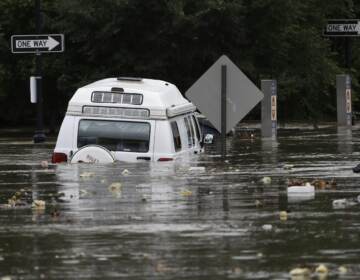 Floodwaters partly submerge a van in Darby, Pa., Monday, Aug. 13, 2018. Climate models predict the region will experience more precipitation going forward. 2018 was Pennsylvania's wettest year on record. (Matt Rourke / Associated Press)

