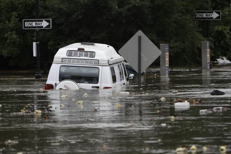 Floodwaters partly submerge a van in Darby, Pa., Monday, Aug. 13, 2018. Climate models predict the region will experience more precipitation going forward. 2018 was Pennsylvania's wettest year on record. (Matt Rourke / Associated Press)

