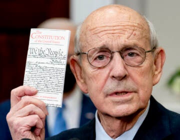 Supreme Court Associate Justice Stephen Breyer holds up a copy of the United States Constitution as he announces his retirement in the Roosevelt Room of the White House in Washington, Thursday, Jan. 27, 2022. (AP Photo/Andrew Harnik)