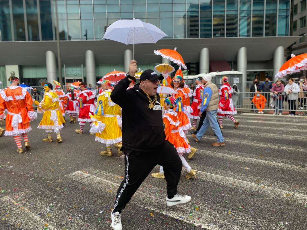 John McGonigal dances with the Mummers along the parade route near City Hall. (Tennyson Donyéa, WHYY)