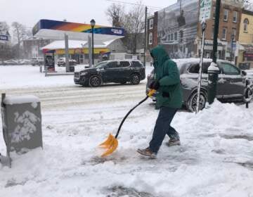 Michael Greene shoveling snow on Baltimore Avenue, West Philadelphia