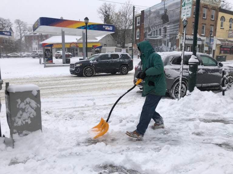 Michael Greene shoveling snow on Baltimore Avenue, West Philadelphia