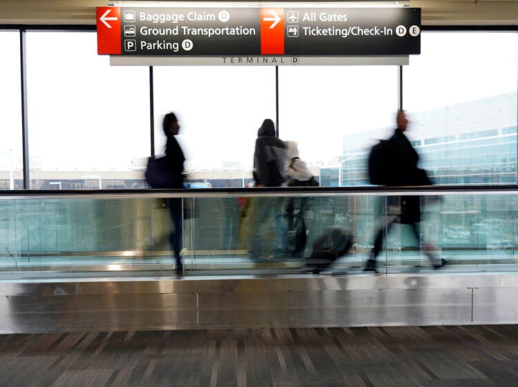 Travelers walk to their gates at the Philadelphia International Airport