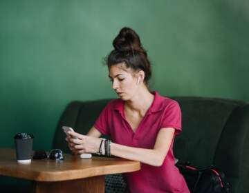 Young woman using Mental Health Apps on cell phone. 