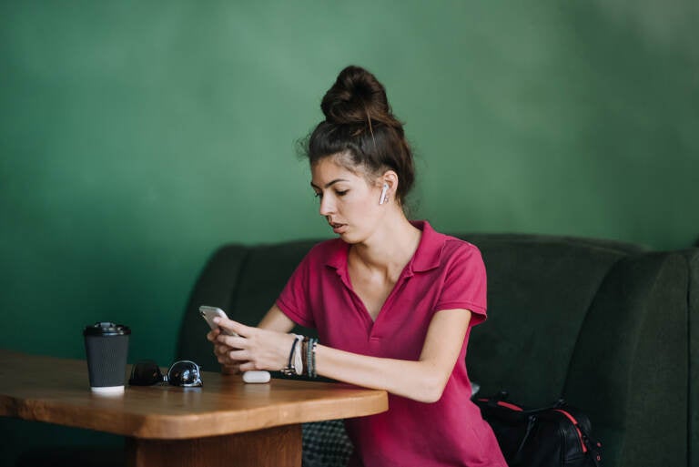 Young woman using Mental Health Apps on cell phone. 