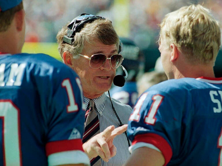 FILE - New York Giants head coach Dan Reeves gives some instructions to his starting quarterback Phil Simms during the third quarter of their game against the Tampa Bay Buccaneers at Giants Stadium in East Rutherford, N.J. on Sunday, Sept. 12, 1993.  Reeves, who won a Super Bowl as a player with the Dallas Cowboys but was best known for a long coaching career highlighted by four more appearances in the title game with the Denver Broncos and Atlanta Falcons, died Saturday, Jan. 1, 2022.  (AP Photo/Mark Lennihan, File)