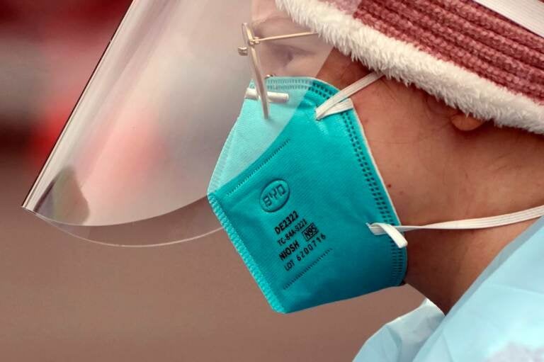 A closeup of a health care worker wearing an N95 mask