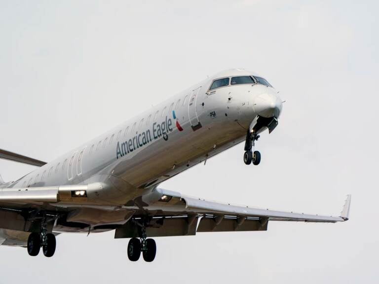 An American Eagle passenger flight lands at Reagan Washington National Airport in Arlington, Va., across the Potomac River from Washington, Wed., Jan. 19, 2022. The airline industry is raising the stakes in a showdown with AT&T and Verizon over plans to launch new 5G wireless service this week, warning that thousands of flights could be grounded or delayed if the rollout takes place near major airports