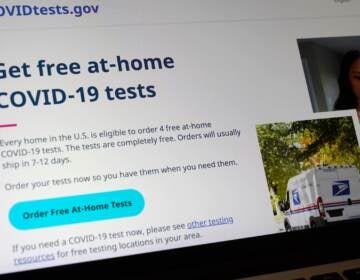 A United States government website is displayed on a computer, Wednesday, Jan. 19, 2022, in Walpole, Mass., that features a page where people can order free, at-home COVID-19 tests. The website, COVIDTests.gov, allows people to order four at-home tests per residence and have them delivered by mail