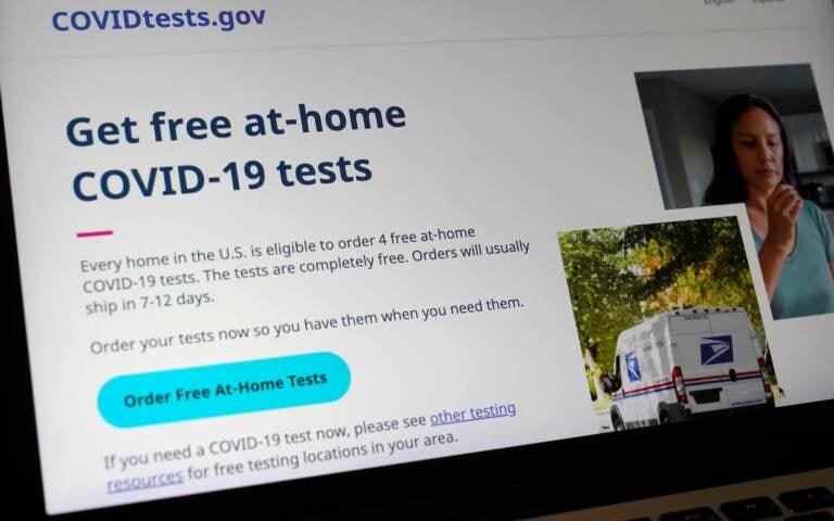 A United States government website is displayed on a computer, Wednesday, Jan. 19, 2022, in Walpole, Mass., that features a page where people can order free, at-home COVID-19 tests. The website, COVIDTests.gov, allows people to order four at-home tests per residence and have them delivered by mail