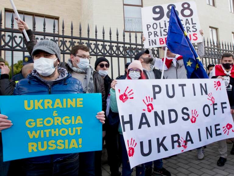 Georgian activists hold posters as they gather in support of Ukraine in front of the Ukrainian Embassy in Tbilisi, Georgia on Sunday, Jan. 23. The British government on Saturday accused Russia of seeking to replace Ukraine's government with a pro-Moscow administration.
Shakh Aivazov/AP
