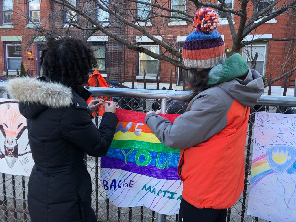 Bache-Martin parents Jerilyn Dressler (left) and Tara Mataraza Desmond hang signs outside of Bache-Martin Elementary school 