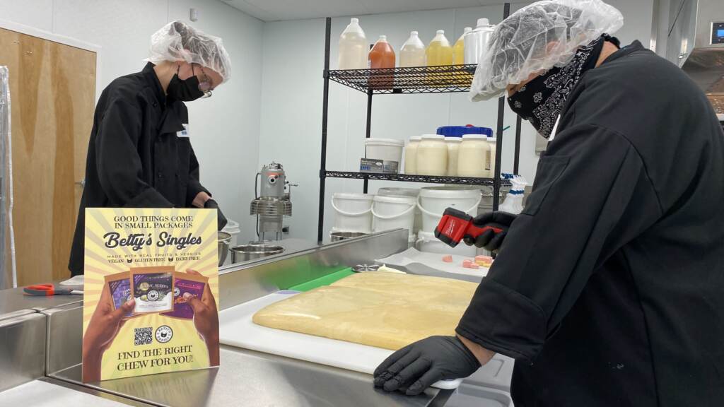 Workers prepare marijuana edibles in a kitchen