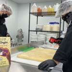 Workers prepare marijuana edibles in a kitchen