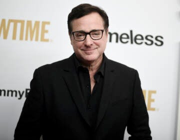 Bob Saget poses for a photo at a press event