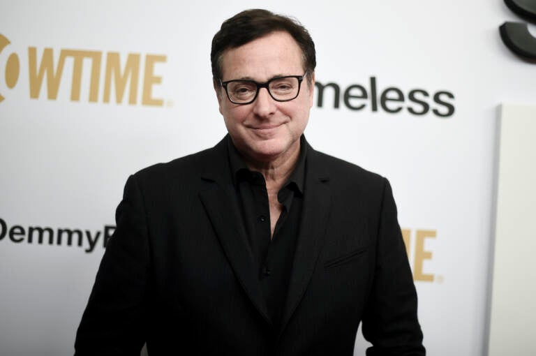 Bob Saget poses for a photo at a press event