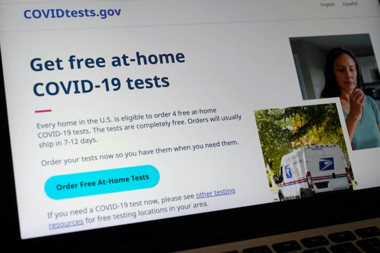 A federal website is displayed on a computer that features a page where people can order free, at-home COVID-19 tests