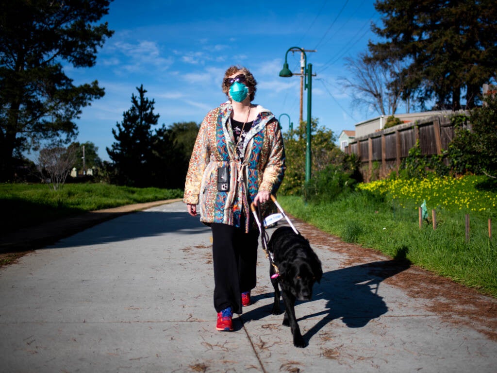 Sassy Outwater-Wright walks through her neighborhood with her guide dog