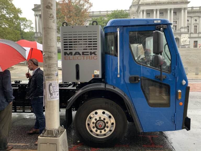 A Mack LR Electric trash truck is parked