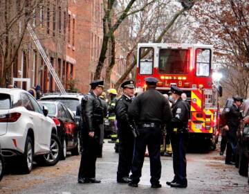 Police confer at the scene of a fire on North 23rd Street