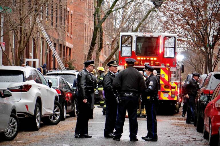 Police confer at the scene of a fire on North 23rd Street