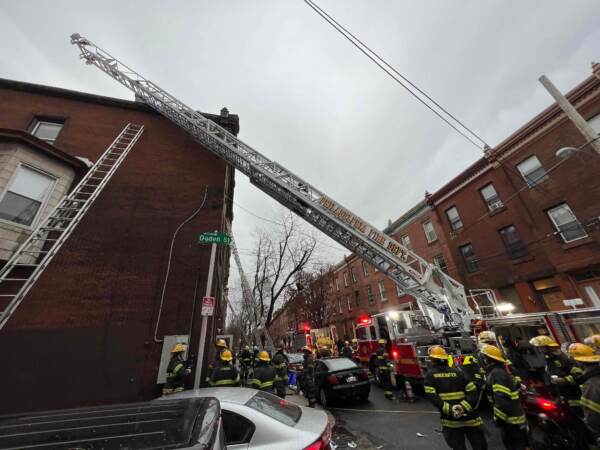 Philadelphia firefighters work at the scene of a deadly fire