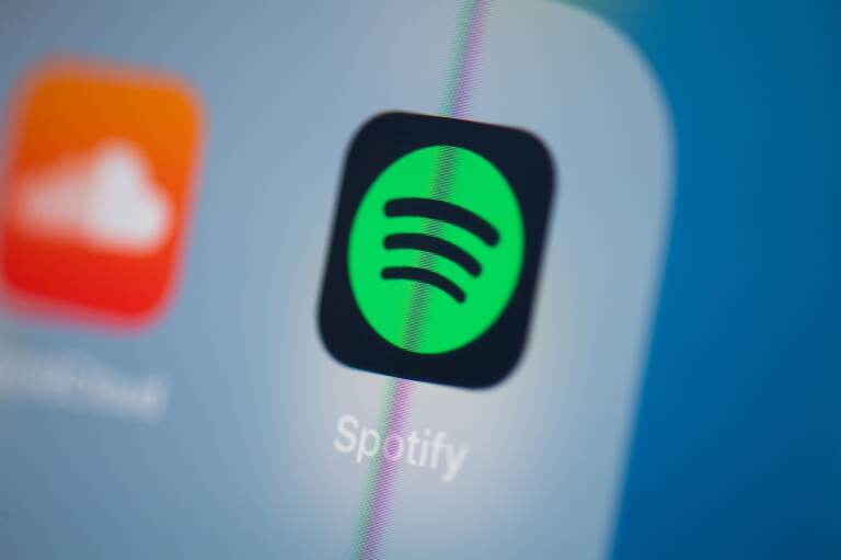 The Spotify logo is seen on a phone screen
