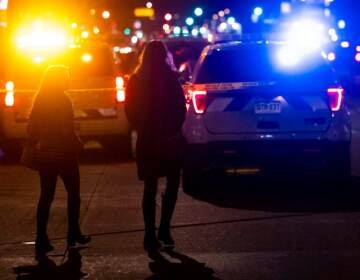 People walk past the Sol Tribe tattoo shop on Broadway where two women were shot and killed and a man injured on December 27, 2021 in Denver, Colorado. (Photo by Michael Ciaglo/Getty Images)