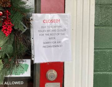 A closed sign is taped to the door of the Main Street Pub