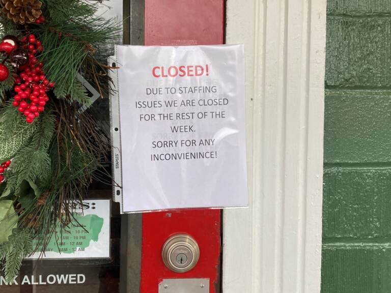 A closed sign is taped to the door of the Main Street Pub