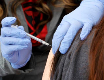 A woman receives a booster shot at a pop-up vaccination clinic in Las Vegas on Dec. 21.
(Ethan Miller/Getty Images)