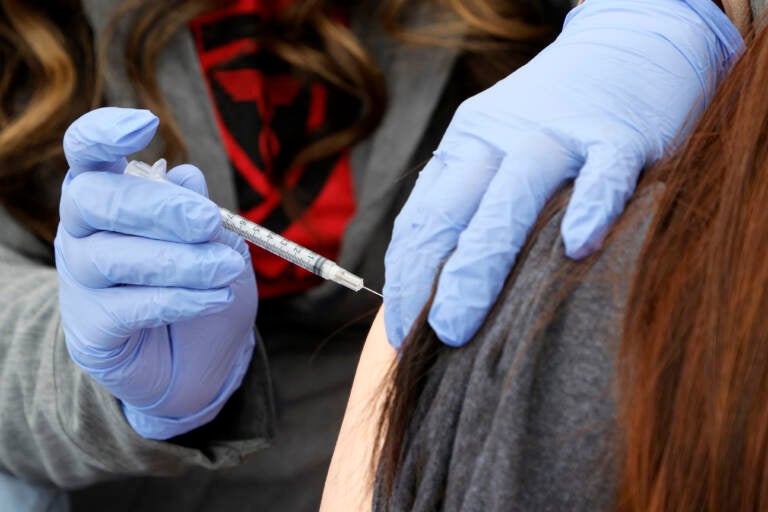 A woman receives a booster shot at a pop-up vaccination clinic in Las Vegas on Dec. 21.
(Ethan Miller/Getty Images)