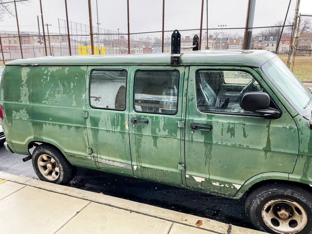 An old hunter green Dodge 1500 truck, known as “Felix”, parked outside