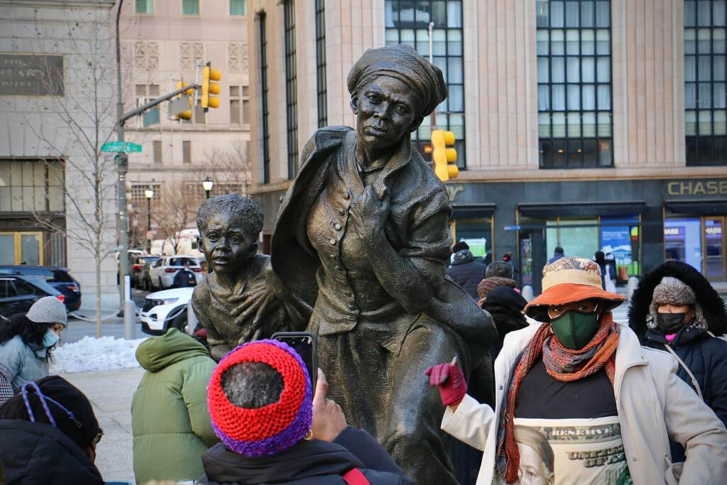 A crowd gathers around the newly unveiled statue of Harriet Tubman