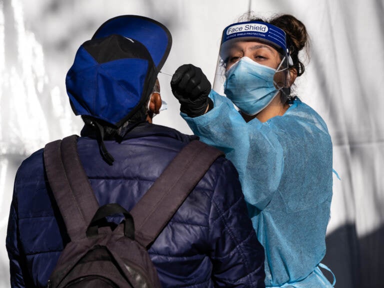 A health care worker administers a test at a Covid-19 testing tent outside a Bay Area Rapid Transit (BART) station in the Mission District of San Francisco, California, U.S., on Monday, Nov. 30, 2020. UCSF and the Latino Task Force held post-holiday Covid-19 testing in four of the most affected neighborhoods in San Francisco, ABC7 San Francisco reports. Photographer: David Odisho/Bloomberg via Getty Images