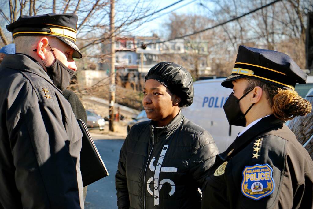 Lendale Rogers stands in between Sgt. Eric Gripp and Commissioner Danielle Outlaw