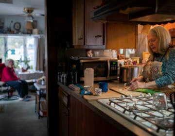 Nancy Rose, right, cooks for her mother in the kitchen