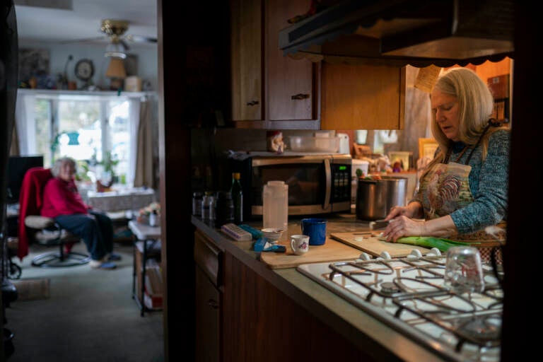 Nancy Rose, right, cooks for her mother in the kitchen